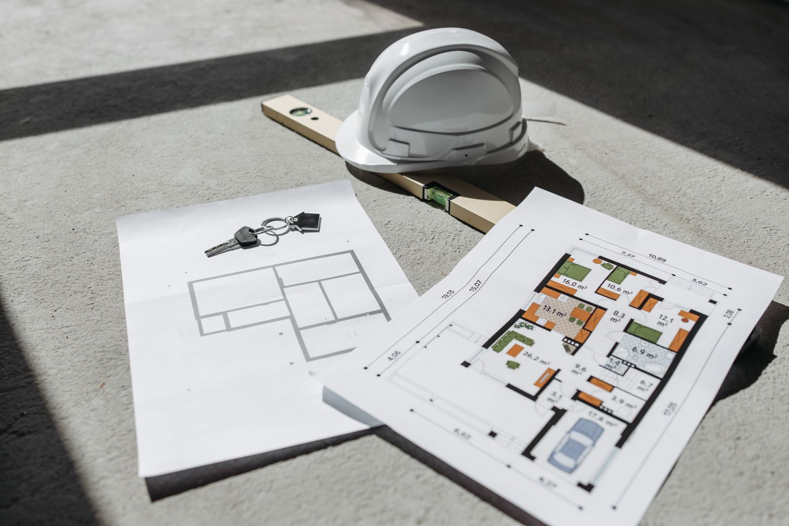 Construction drawings with a hard hat.