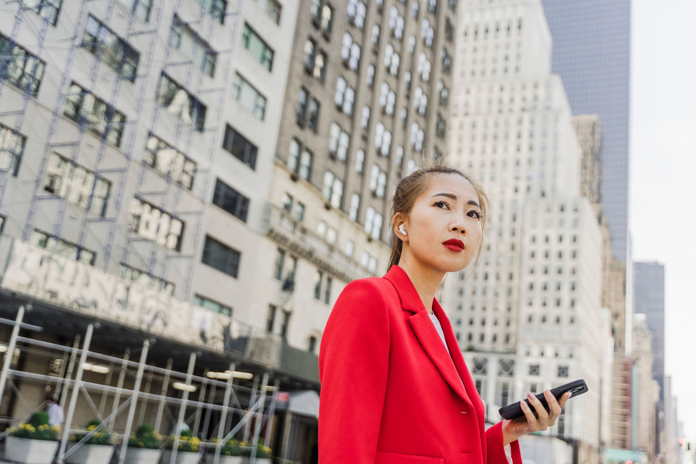 Property consultant with buildings behind her.