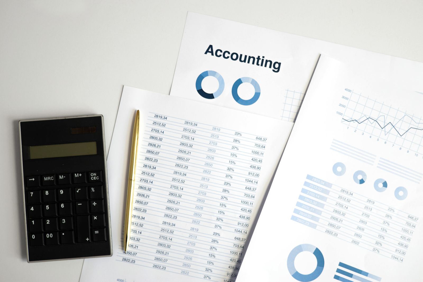 Accounting printouts and a calculator on a desk.