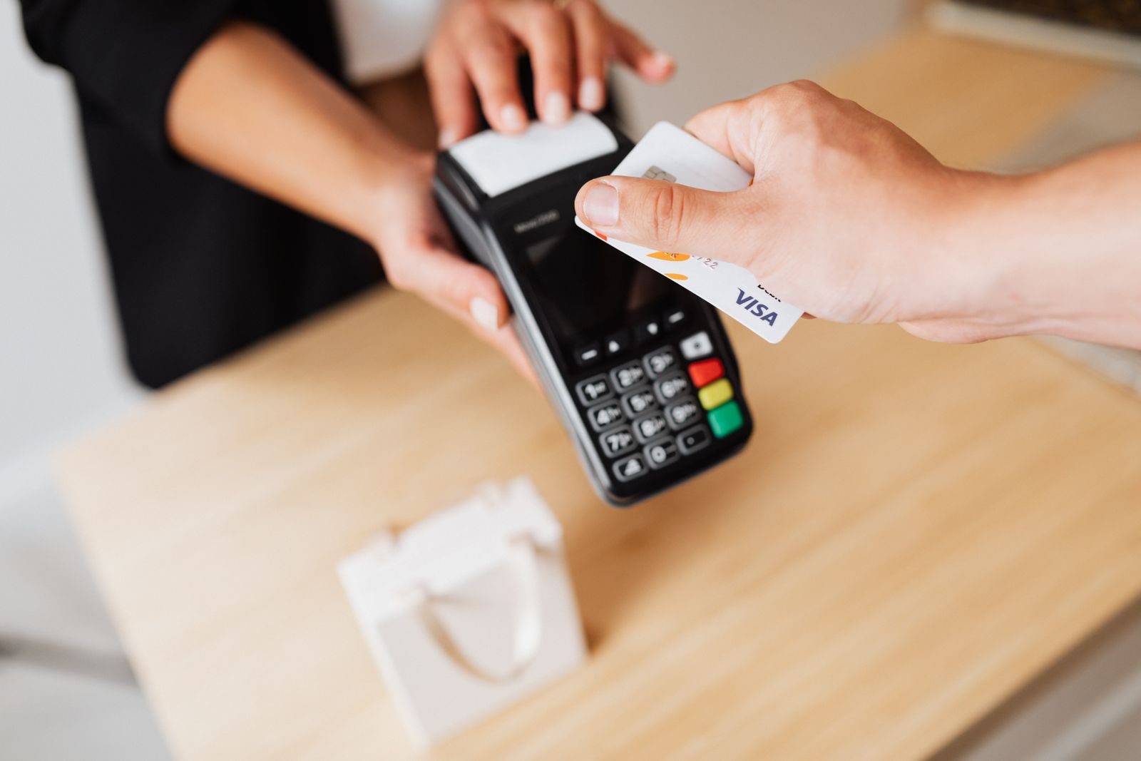 Card payment on a terminal at a counter.