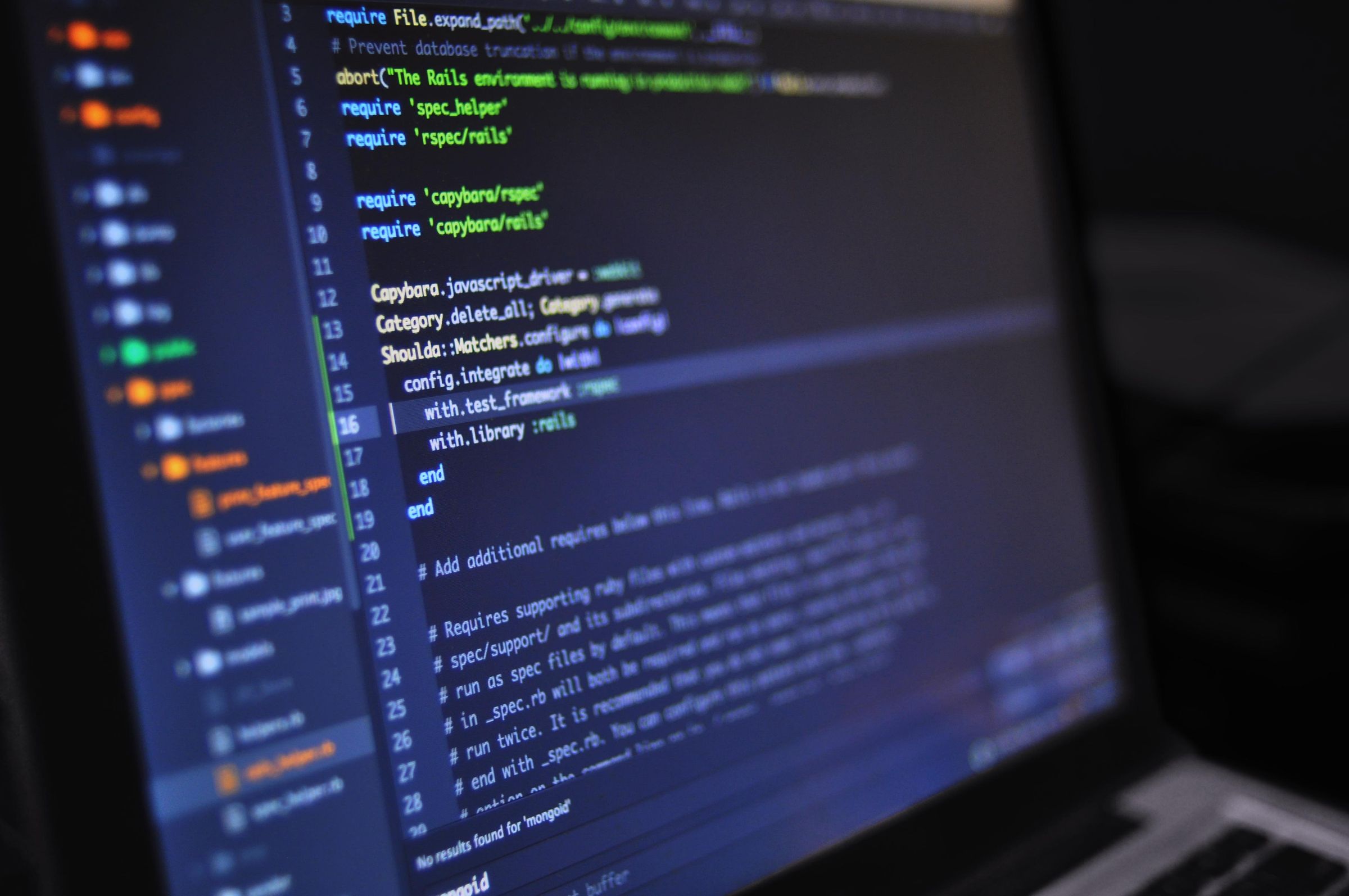 Application source code open on a laptop screen.